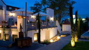 a villa with a swimming pool at night at Hotel Vorfelder in Walldorf