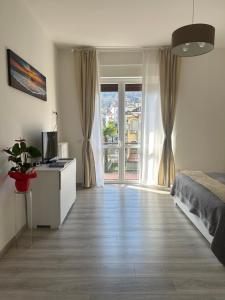 a bedroom with a bed and a large window at Fior&Iris Apartments in Stresa