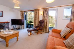 a living room with a couch and a tv at Bens Cottage in Chapel Stile