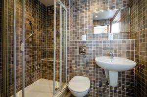 a bathroom with a toilet and a sink at Bens Cottage in Chapel Stile +10 photos