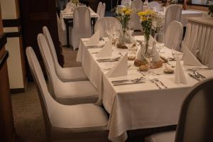 a long table with white tables and white chairs at Hotel U Kaple in Děčín