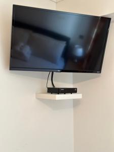 a flat screen tv hanging on a wall at Southover Beach in Woolacombe