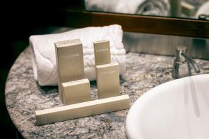 two boxes ofodorizers sitting on a counter next to towels at Hotel Sansi Barcelona in Barcelona