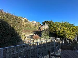 a walkway leading up to a hill with a fence at Southover Beach in Woolacombe