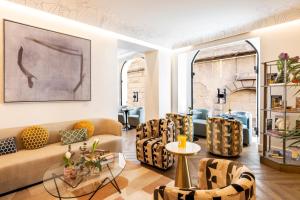 a living room with a couch and chairs at Nerva Boutique Hotel in Rome