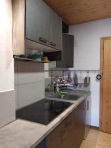 a kitchen with a sink and a counter top at Studio Meditazione e Yoga in Ossana +8 photos