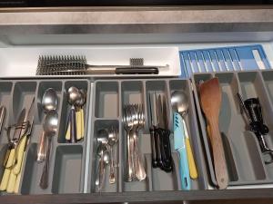 a drawer with silver utensils in it at Mansarda Meditazione e Yoga in Ossana