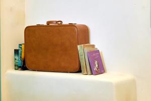 a suitcase sitting on top of a table with books at La casa di Chele in Palermo