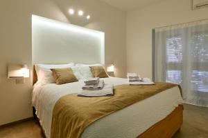 a bedroom with a large bed with towels on it at La casa di Chele in Palermo