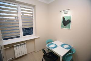 a room with a table and chairs and a window at Cathedral Apartments in Vilnius