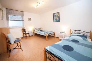 a bedroom with two beds and a window at Ferienwohnung Haas in Lauda-Königshofen