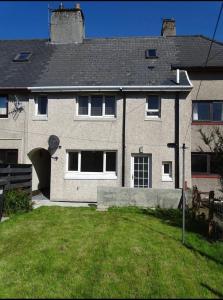 a large house with a grass yard in front of it at Discover Lewis and Harris in Stornoway