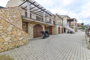 a motorcycle parked next to a stone building at Casa Lydia in Rio nellʼElba