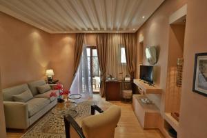 a living room with a couch and a table at Riad Mayfez Suites & Spa in Fès