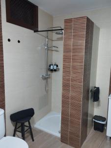 a bathroom with a shower with a toilet and a stool at BellAltea in Altea