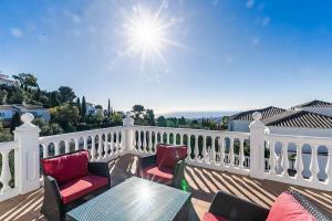 a patio with two chairs and a table on a balcony at 88-Exclusive Villa with Private Pool in Mijas, Malaga in Mijas