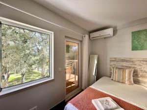 a bedroom with a bed and a large window at Vilamoura Marina Mar 2 With Pool by Homing in Vilamoura +28 photos