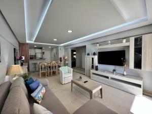 a living room with a couch and a flat screen tv at Vilamoura Marina Mar 2 With Pool by Homing in Vilamoura