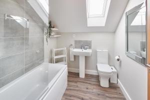 a white bathroom with a sink and a toilet at Host & Stay - Aidan Gardens in Durham