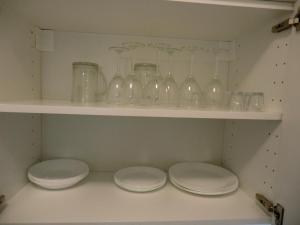 a shelf with glass jars and plates on it at Apartmány Karlov pod Pradědem in Malá Morávka