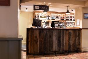 a bar with a wooden counter in a room at The Springfield Inn by Innkeeper's Collection in Lowdham