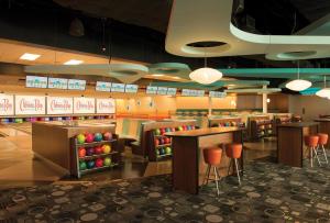 a restaurant with tables and stools in a cafeteria at Universal's Cabana Bay Beach Resort in Orlando