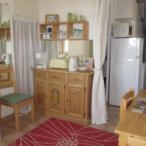 a kitchen with a wooden cabinet and a refrigerator at Appartement les Balcons d'Azur in Vernègues