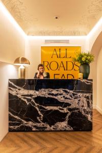 a woman standing at a podium in a room at Nerva Boutique Hotel in Rome