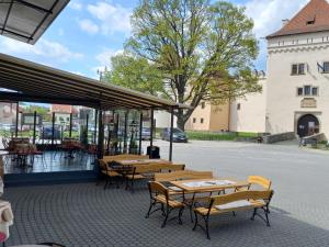 a group of tables and chairs on a patio at Penzión Berg in Kežmarok