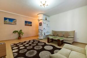 a living room with a couch and a table at Nadezhda Apartments in Samal in Almaty