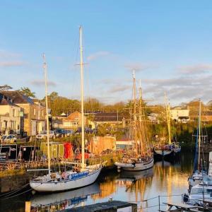 a group of boats docked in a harbor at Stunning Yacht Sea Lion in Charlestown Harbour, Cornwall in Charlestown