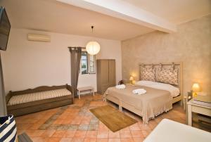 a bedroom with a bed and a bench in a room at Paloma Luxury Studios in Panormos Kalymnos