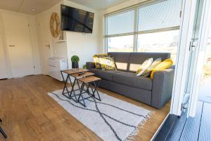 a living room with a couch and a table at Houseboats Lemmer in Lemmer