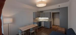 a kitchen with a table and chairs in a room at Delta Hotel Apartments in San Donato Milanese