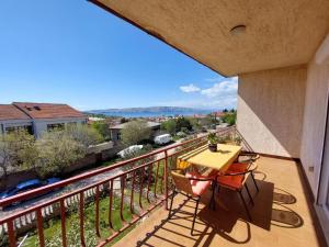 a balcony with a table and a view of a city at Apartment Durda in Senj