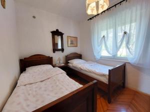 two beds in a room with a window at Apartment Durda in Senj