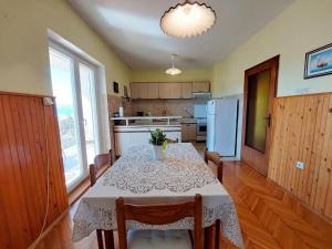 a kitchen with a table with a white table cloth at Apartment Durda in Senj