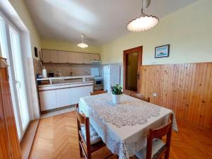 a kitchen with a table with a white table cloth at Apartment Durda in Senj +20 photos
