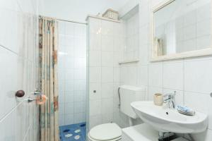 a white bathroom with a toilet and a sink at House Ivo in Stomorska +19 photos