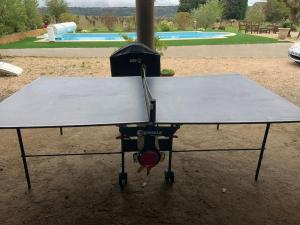 a ping pong table in front of a pool at Mas 19e climatisé avec piscine à usage exclusif in Roquemaure