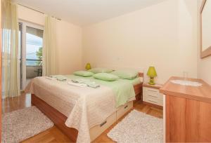 a bedroom with a large bed and a window at Apartment Temza in Krilo