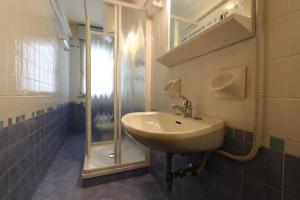 a bathroom with a sink and a shower at Appartamenti Erica in Bibione