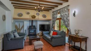 a living room with two couches and a fireplace at Almendros Antequera - Los Nogales by Ruralidays in Antequera