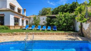 a villa with a swimming pool in front of a house at Almendros Antequera - Los Nogales by Ruralidays in Antequera