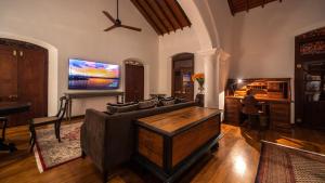 a living room with a couch and a tv at Maya Tangalle in Tangalle