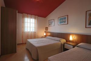 A bed or beds in a room at Villaggio Euro Residence Club