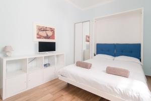 um quarto branco com uma cama grande e uma televisão em Taaac Apartment - The House Of Travelers em Como