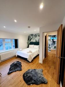 a bedroom with a bed and two towels on the floor at 2 Southwell Road - Luxurious City Centre Apartments in Norwich