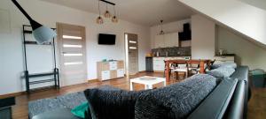 a living room with a couch and a table at Smerekowa Ostoja in Smerek