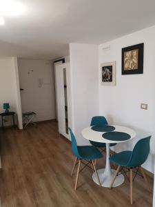 a room with a table and four chairs and a table at HomyHome in Civitavecchia